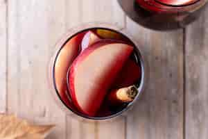 Free photo autumn sangria with pear and apple on wooden table