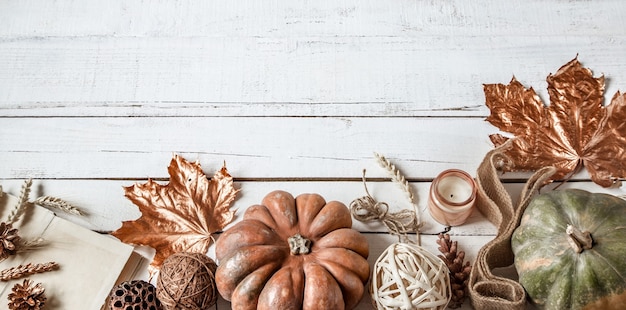 Autumn wall with decorative items and pumpkin.