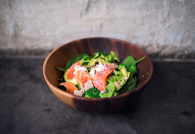 Avocado salmon salad healthy food in rustic style