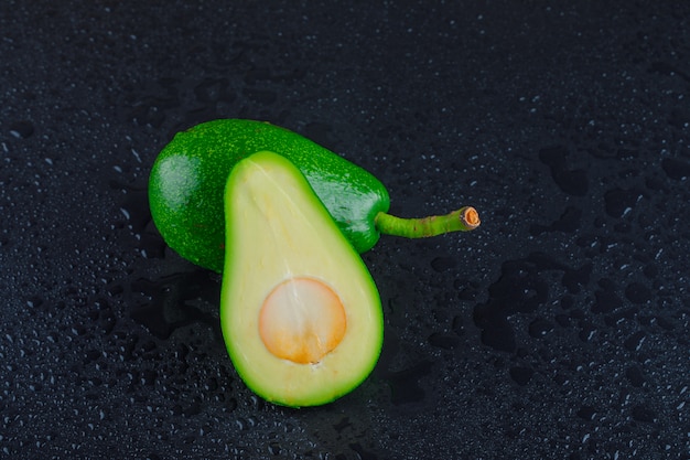 Free photo avocados on a dark grey table. top view.