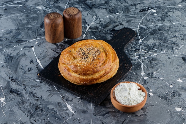 Azerbaijan national pastry with uncooked chicken egg and a glass pitcher of fresh milk