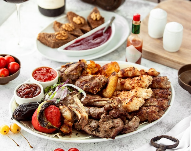 Azerbaijani kebab platter with lamb chicken vegetable kebabs