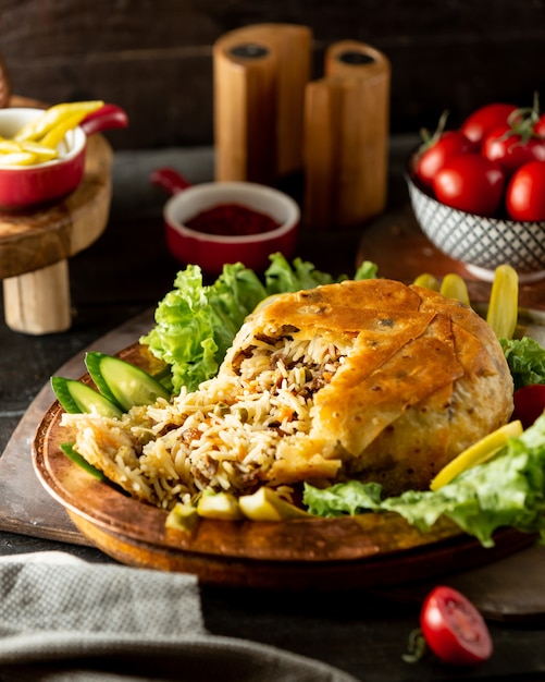 Azerbaijani rice dish shah pilaf flatbread crust filled with rice meat and peas