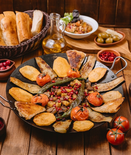 Azerbaijani saj cizbiz cooked with aubergine potato tomato and pepper in cast iron pan