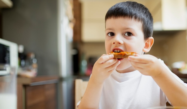 Baby boy having a snack at home