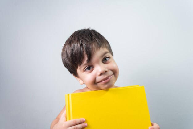 Baby boy holding yellow book