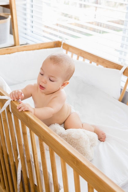 Baby boy playing on a cradle