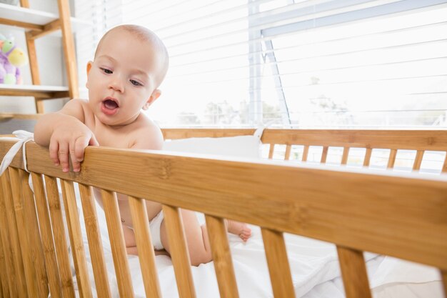 Baby boy playing on a cradle