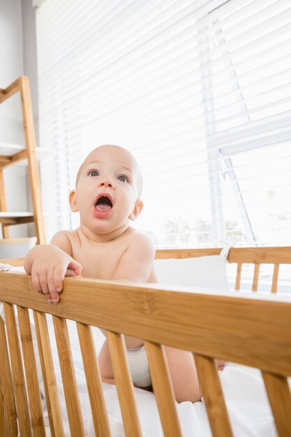 Baby boy playing on a cradle