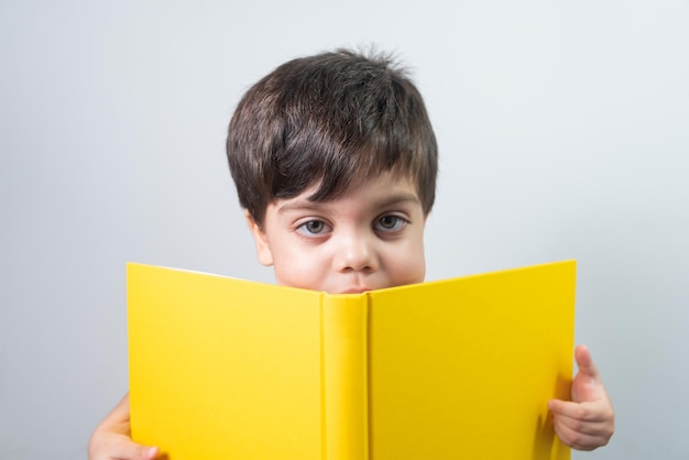 Baby boy reading yellow book