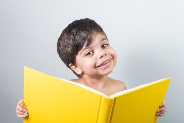 Baby boy reading yellow book