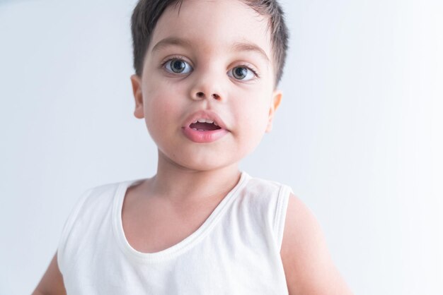 Baby boy in white tshirt over white background