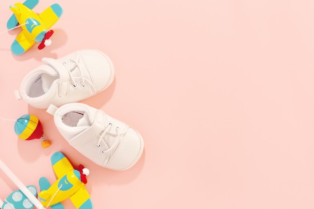 Free photo baby concept. flat lay accessories with baby shoes and wooden toy plane.