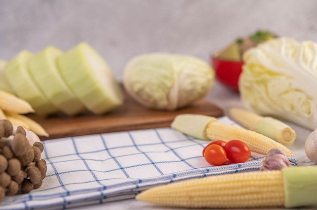 Baby corn, tomatoes, cabbage and mushrooms on fabric