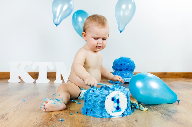 "Baby eating birthday cake. "