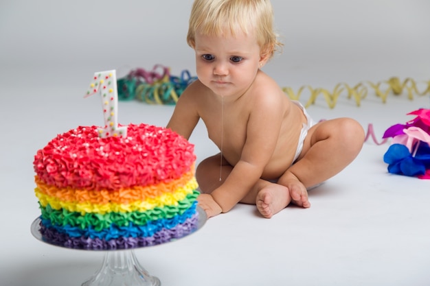 Baby girl celebrating her first bithday with gourmet cake and ba