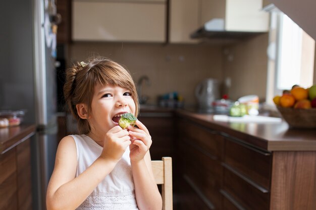 Baby girl having a snack at home