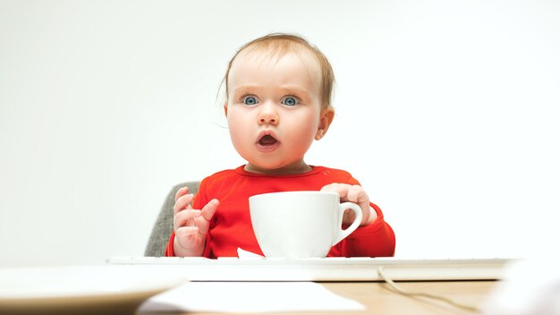 Baby girl sitting with cup of coffee