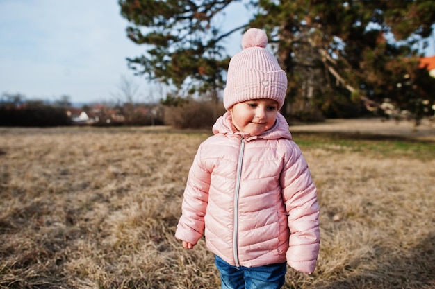 Free photo baby girl wear pink jacket walking at valtice park czech republic