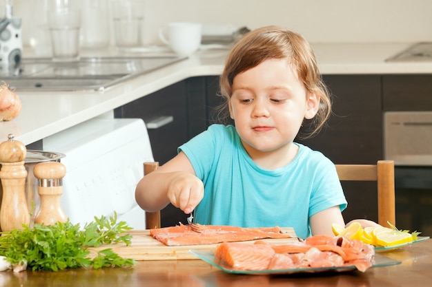 Free Photo baby housewife cooking salmon