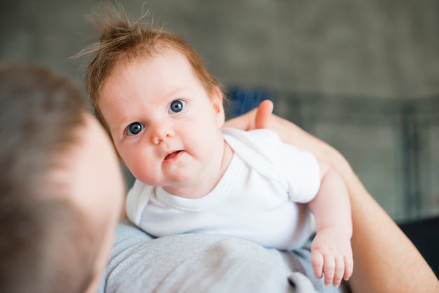 Free photo baby hugged by lovely dad