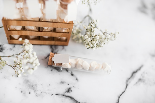 Free Photo baby's-breath flowers and marshmallow test tubes on textured background