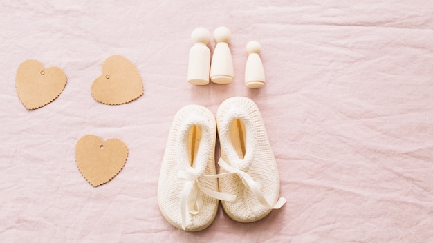 Baby-shoes and paper hearts