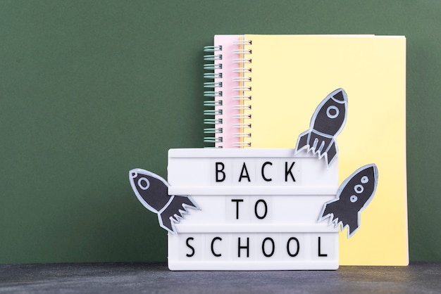 Free photo back to school background with notebooks and light box