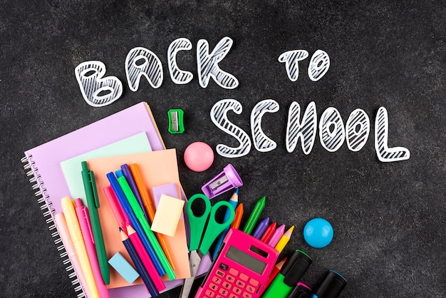 Back to school background with school supplies on chalkboard