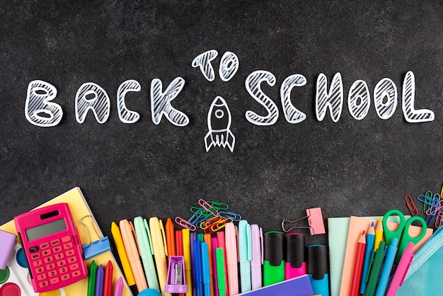 Free Photo back to school background with school supplies on chalkboard