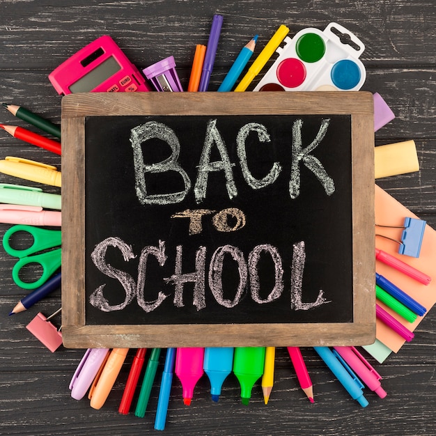 Free photo back to school background with school supplies and chalkboard