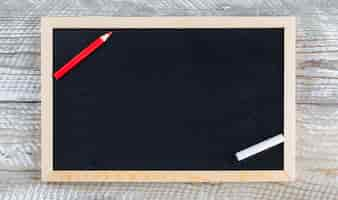 Free photo back to school concept with pencil, chalk on wooden background flat lay.