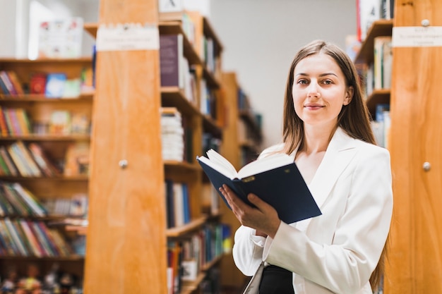 Back to school concept with woman studying in library