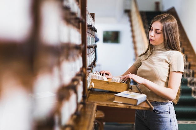 Back to school concept with woman studying in library