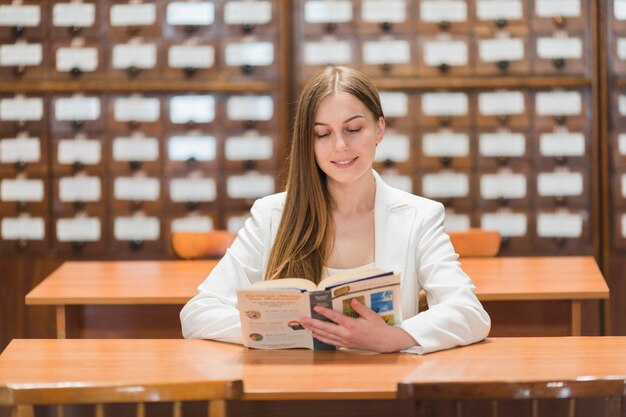 Back to school concept with woman studying in library