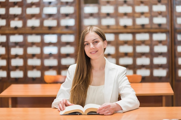 Back to school concept with woman studying in library