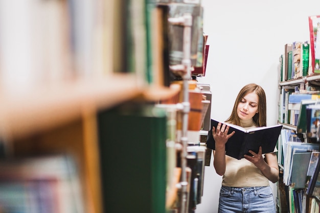 Back to school concept with woman studying in library