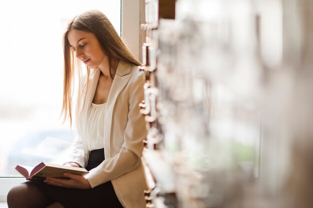 Back to school concept with woman studying in library