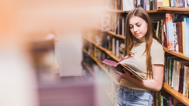 Back to school concept with woman studying in library