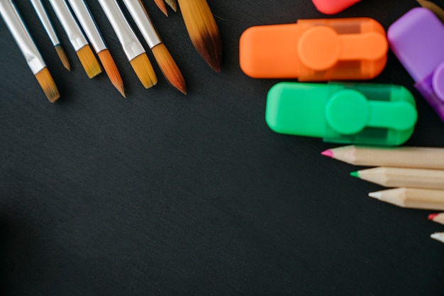 Back to school decoration with paint brushes and pencils