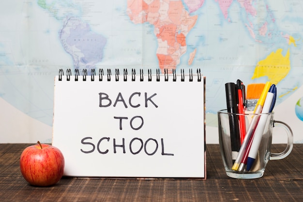 Free photo back to school greeting with world map background