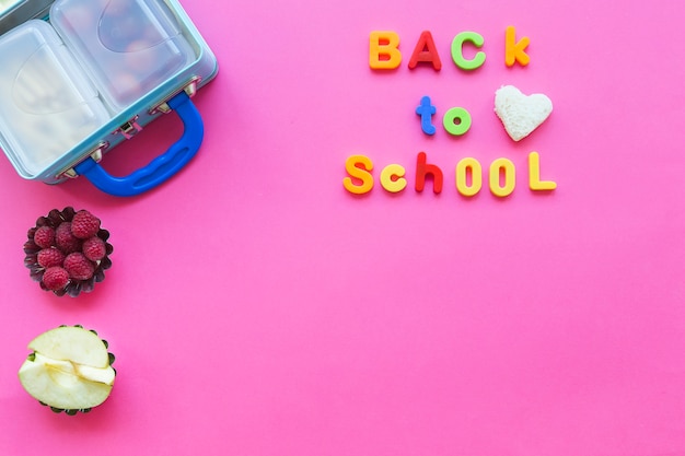 Free photo back to school writing near fruits and lunchbox