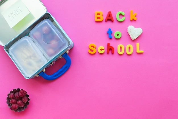 Free photo back to school writing near lunchbox and raspberries