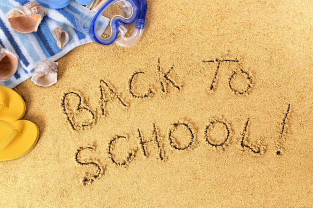 "back to school" written on the beach 