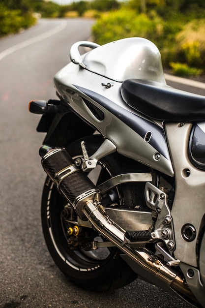 Back seat and wheel of a silver color motorcycle.