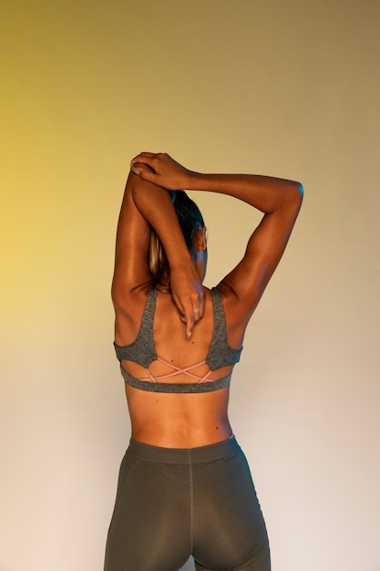 Back view of athlete stretching