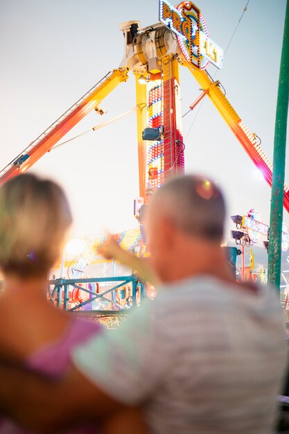 Back view blurred couple at theme park 