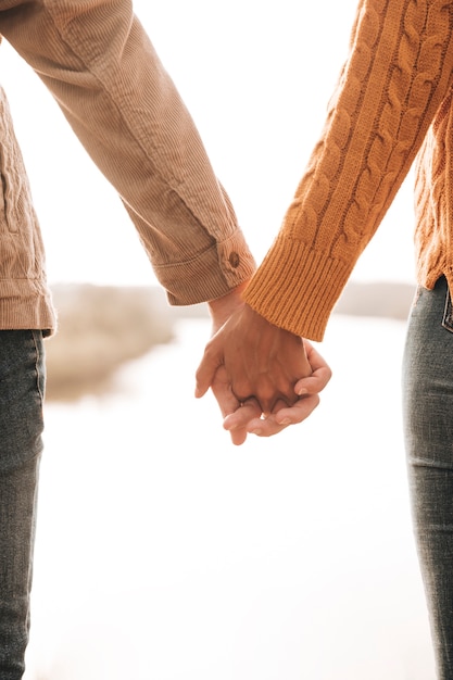 Free photo back view couple holding hands