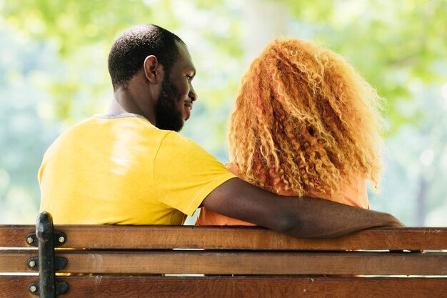 Back view of couple sitting on a bench