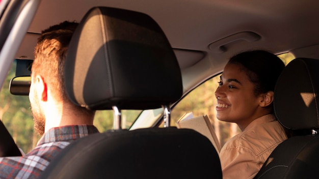 Back view couple traveling by car